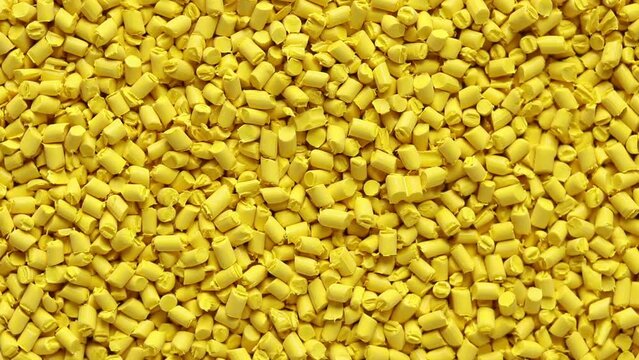 top view of yellow plastic resin ( Masterbatch ) rotation background