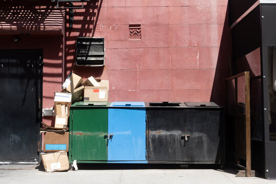 Trash and recycling cans in the city