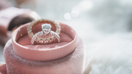 Close up of diamond ring in the pink box with sunlight and shadow. Love, valentine, relationship...