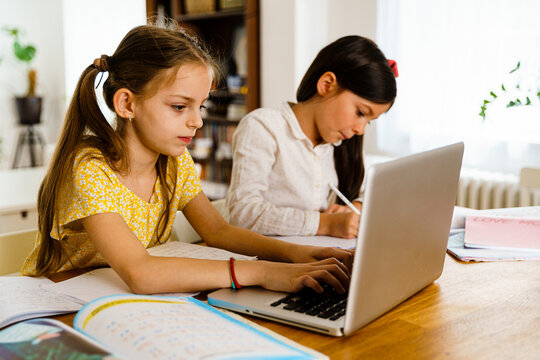 Little girl using internet for homeschooling 