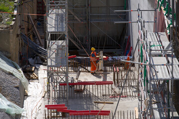 Aerial view of highway enclosure construction site with construction worker loading armoring iron at City of Z&uuml;rich on a sunny spring day. Photo taken May 16th, 2022, Zurich, Switzerland.