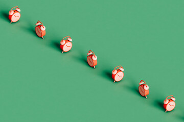 a row of many pink alarm cloks 