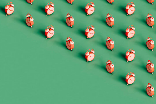 many pink alarm cloks covering half of the green background