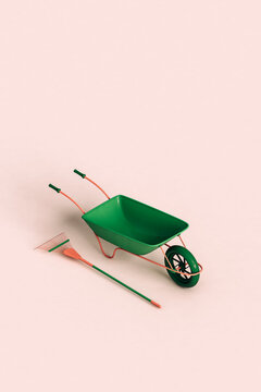 green rake and wheelbarrow. 3d render
