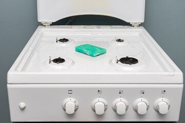 a rag and gel lie on the gas stove during cleaning