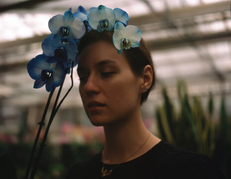a woman with a blue flower crown 