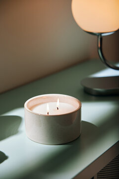 Ceramic cup with candle in sunlight
