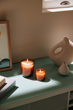 Burning candles placed in sunlight
