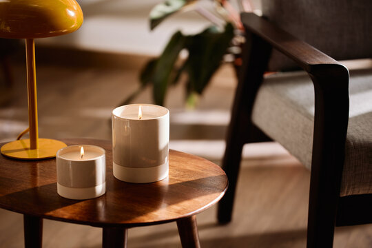 Candles and lamp near armchair