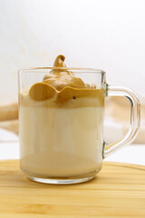 Dalgona coffee or whipped instant coffee. New popular food and drink trend. Light background. Vertical photo
