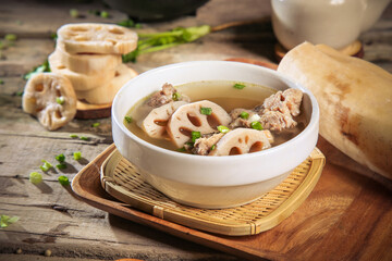asian Chinese traditional herbal double boiled chicken pork meat hot soup with vegetables in bamboo bowl on retro kitchen dining background healthy menu