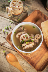 asian Chinese traditional herbal double boiled chicken pork meat hot soup with vegetables in bamboo...