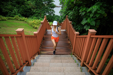 Fitness woman runner running on seaside boardwalk