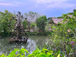 water mill or turbine baler is installed in a garden pond. It is a tool that can help increase oxygen in water