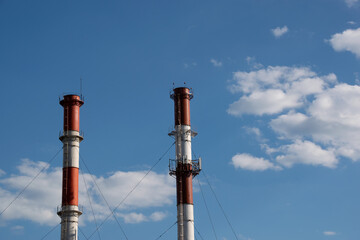 red and white pipes on the background of the sky with clouds
