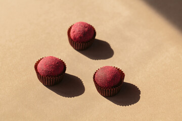 Healthy raw energy balls with cocoa on a beige background. Vegan homemade chocolate truffles Candy