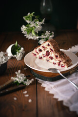 Homemade cake with cherries and cream on a wooden table. Dessert close-up. 
