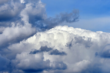 Cumulus clouds. White clouds on the blue sky close-up.