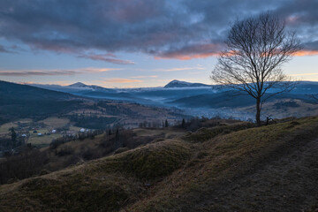 Picturesque pre sunrise morning above late autumn mountain countryside. Ukraine, Carpathian Mountains, Hoverla and Petros tops in far.