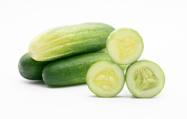 whole cucumber with some pieces isolated on white background