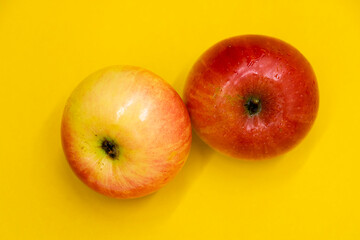 apple with drop of water isolate on yellow background.