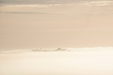 Beautiful vibrant landscape image of sea of fog rolling across South Downs English countryside during Spring sunrise