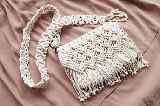 Handmade macrame cotton сross-body bag. Eco bag for women from cotton rope. Scandinavian style bag.  Creme tones, sustainable fashion accessories. Close up image