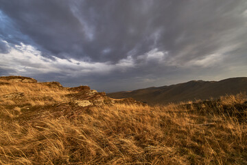 The sunlit part of the mountain, through clouds.