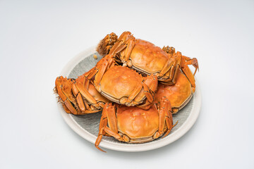 A dish of hairy crabs and river crabs on a white background © Allen Chen