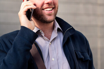 smiling unrecognizable businessman talking by phone, concept of entrepreneurship and business, copy space for text