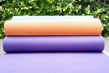 close up of colorful yoga mat on the table, sport and healthy concept