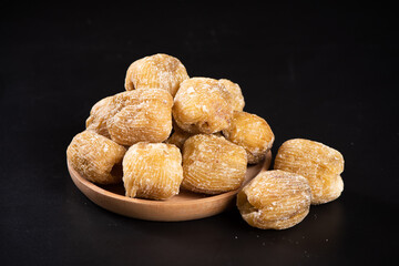 dry Candied dates on black background