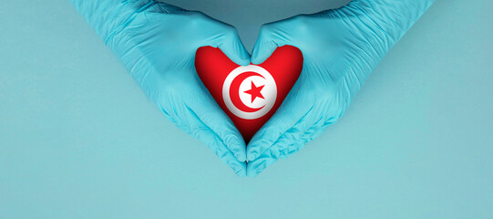 Doctors hands wearing blue surgical gloves making hear shape symbol with tunisia flag