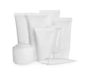Blank tubes and jars of cosmetic products on white background