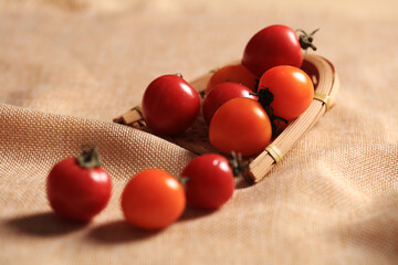 Cherry tomatoes are in the bamboo basket