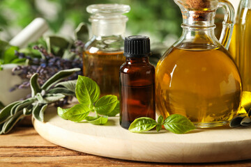 Different fresh herbs with oils on wooden table, closeup