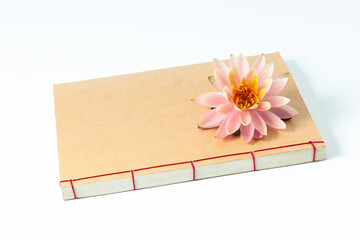 The Buddhist book and a pink lotus flower