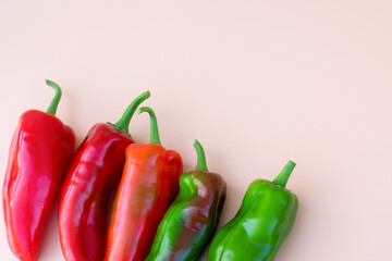 Harvest of different multi colored red green sweet bell peppers. Row of organic eco vegetables from countryside garden