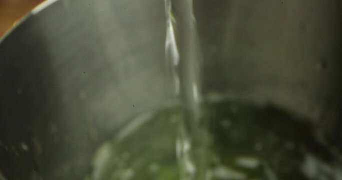 close-up water pours into the vessel.