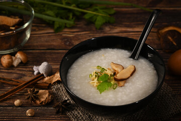 Nutritious rice porridge with soft boiled egg, shiitake mushroom, slice ginger and slice scallion for light meal