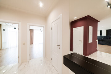 interior design corridor in a new house with light walls and a red wall