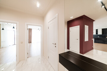 interior design corridor in a new house with light walls and a red wall