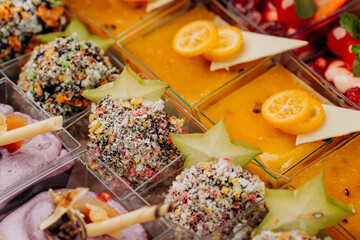 Different portions of desserts with jelly and fruit in a box are ready for delivery