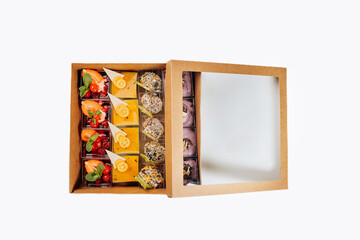 Different portions of desserts with jelly and fruit in a box are ready for delivery