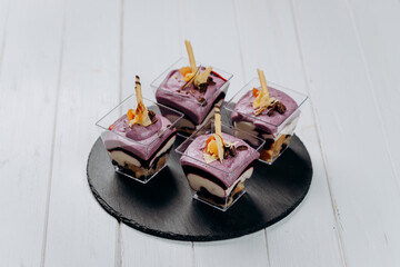 Different portions of desserts with jelly and fruit are ready for delivery