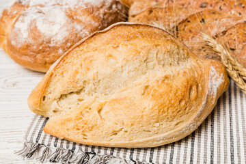 Homemade natural breads. Different kinds of fresh bread as background, perspective view with copy space