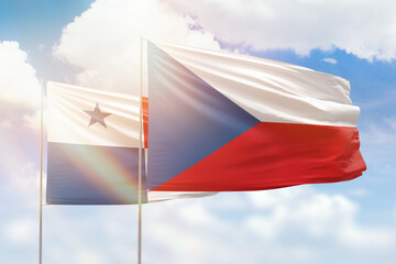 Sunny blue sky and flags of czechia and panama