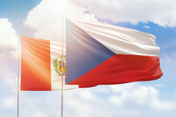 Sunny blue sky and flags of czechia and peru