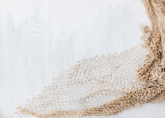 Sea white wooden background with fishing net. Top view.