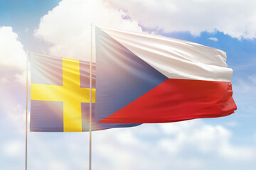 Sunny blue sky and flags of czechia and sweden